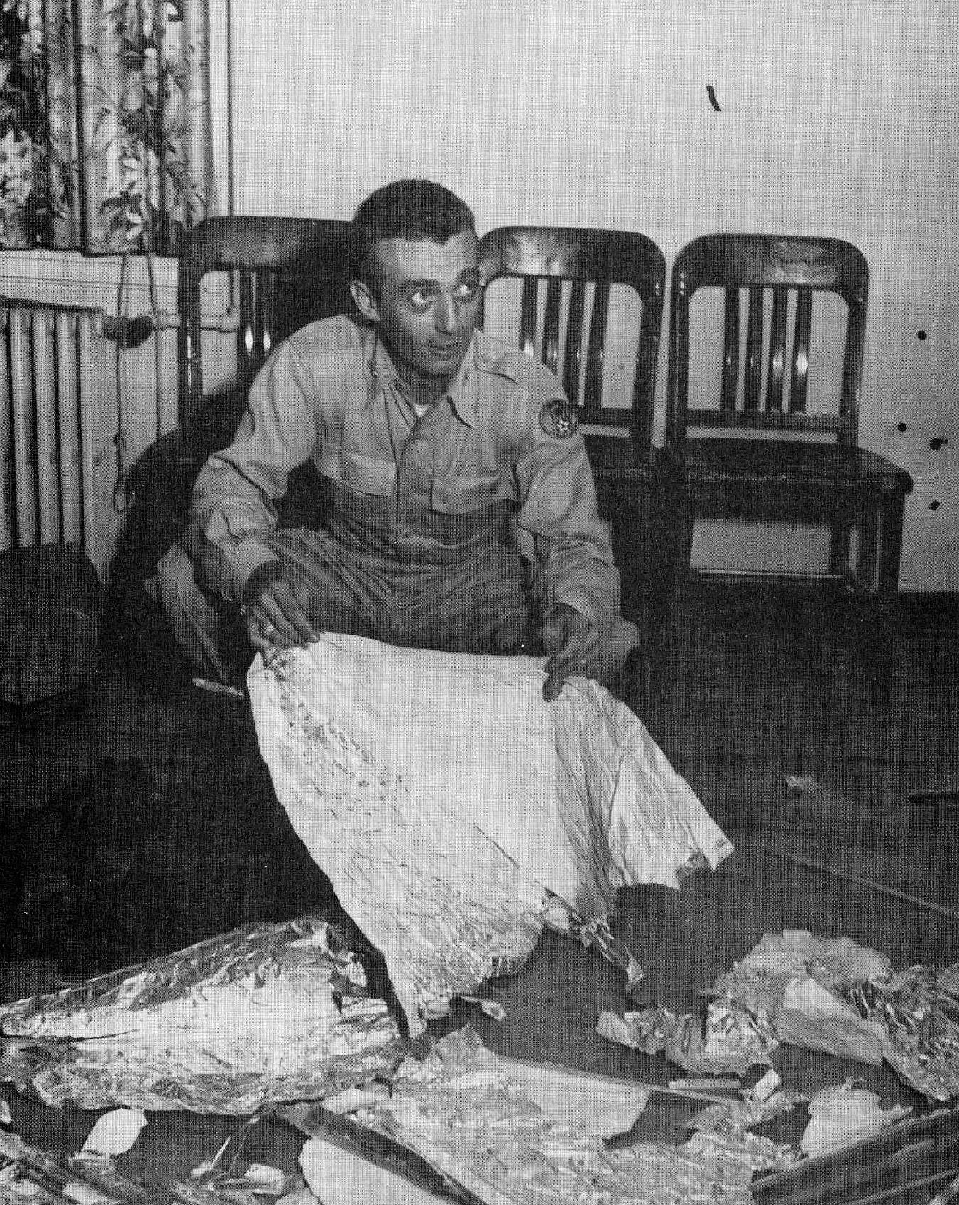 Major Jesse Marcel, Sr., the Chief Intelligence Officer at the Roswell Army Air Force Base in 1947. Marcel claims that he was ordered to pose with bogus baloon debris so that the incident would become a laughingstock