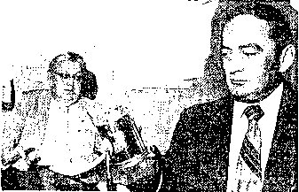THE LANTERN - Carbondale's Acting Police Chief Francis Dottle examines the railroad lantern that was pulled from the pond. Authorities insist the light is evidence that the UFO sighting was "a giant hoax." Behind Dottle is Carbondale Mayor A.J. Kaufman. 